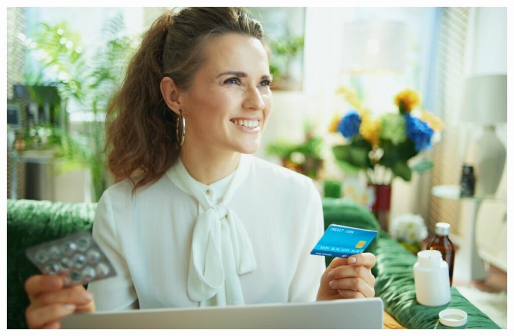 Woman smiling with her RxAdvantage card in her hand.